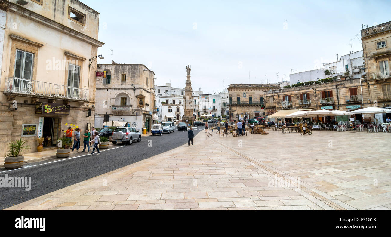 main square with tourists in Ostuni, Italy. Stock Photo