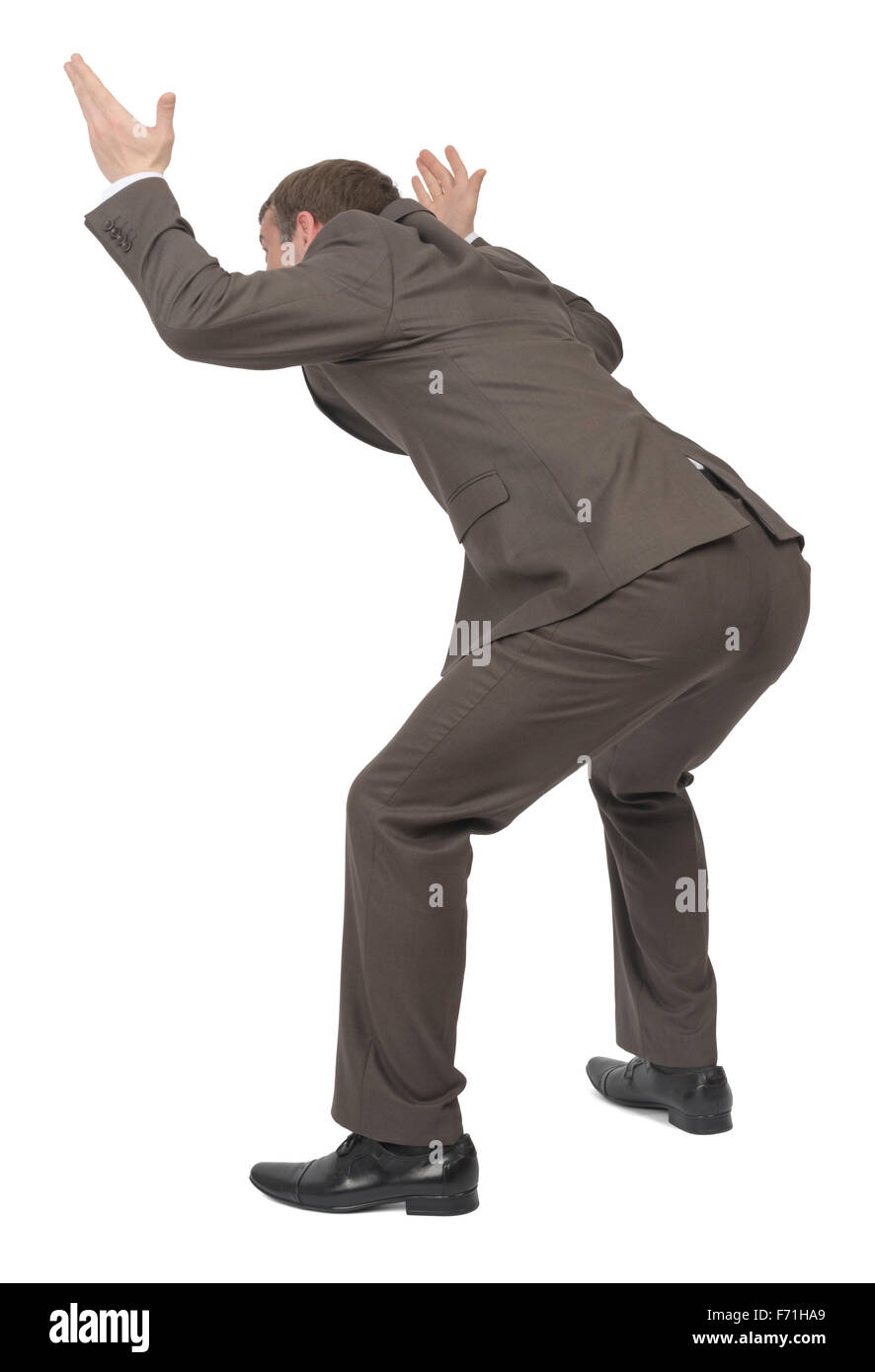 Businessman under heavy empty space, rear view Stock Photo - Alamy