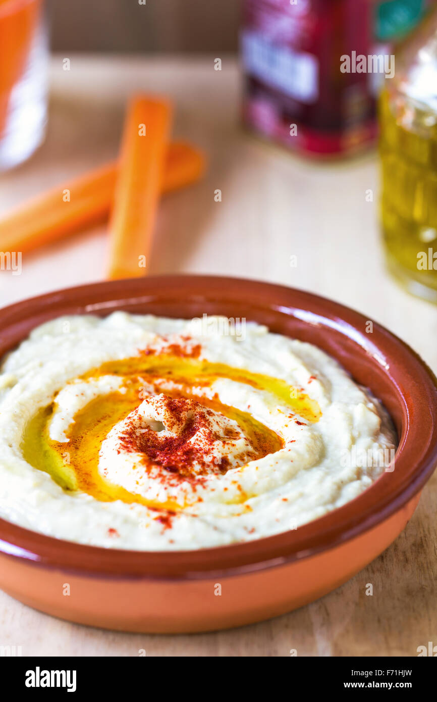 Homemade Hummus by some carrot sticks Stock Photo Alamy