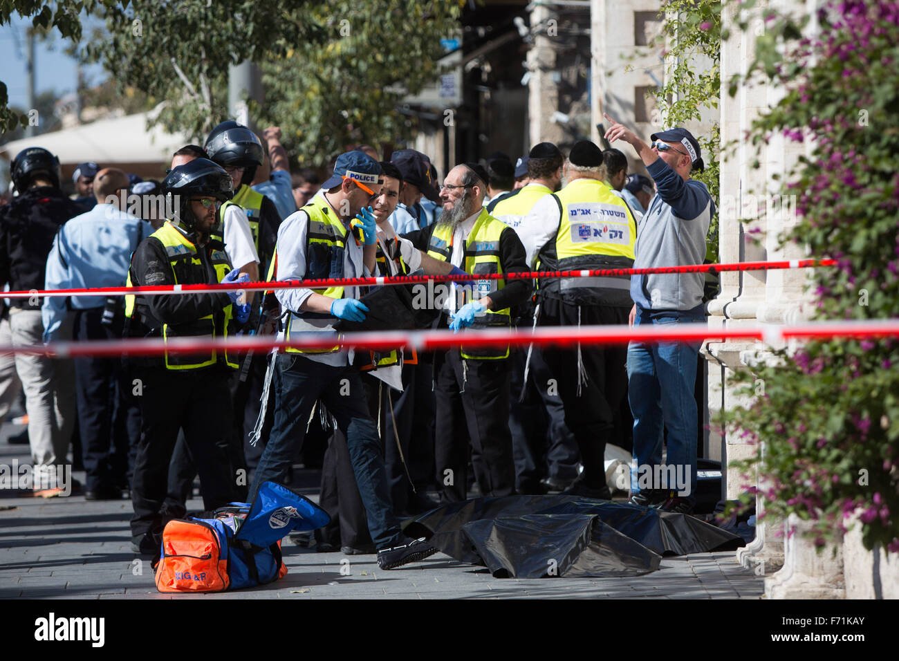 Jerusalem, Jerusalem. 23rd Nov, 2015. Israeli security forces and members of ZAKA team (a voluntary organisation responding to tragic incidents in Israel) work next to the covered body of a Palestinian girl at the scene of a stabbing attack outside the Mahne Yehuda, a busy outdoor market in central Jerusalem, on Nov. 23, 2015. Three Palestinian attackers were shot dead on Monday by Israeli security forces after they launched stabbing attacks in a new surge of tensions between the two sides. Credit:  JINI/Xinhua/Alamy Live News Stock Photo