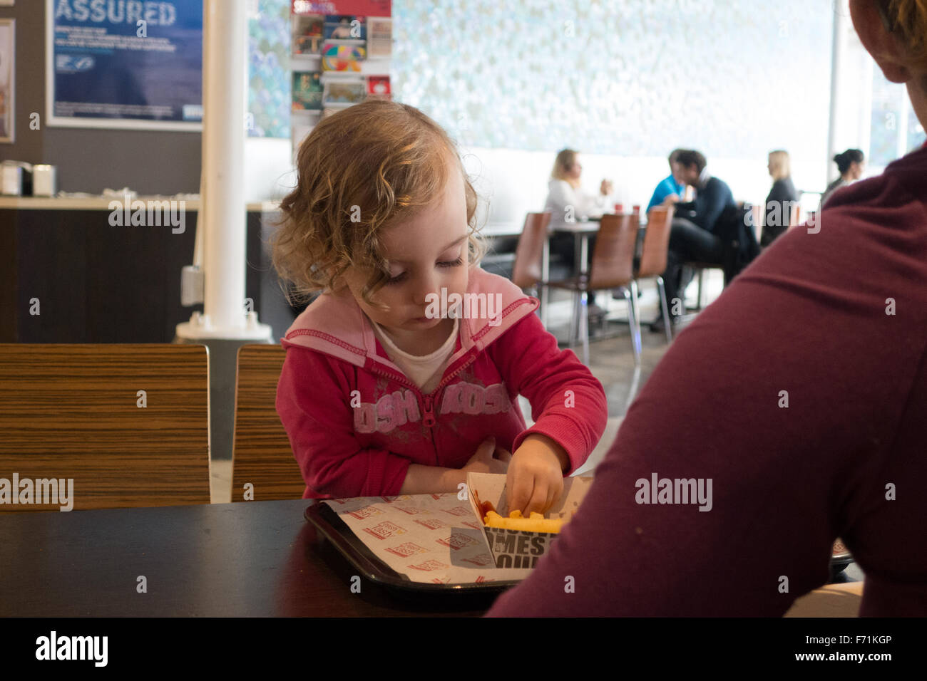 young girl eating cafe Stock Photo