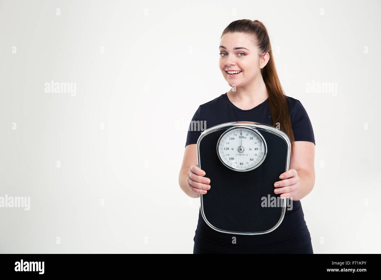 Slimdown success. Happy joyful young woman girl on weighing scale raising  her arms hands. Healthy lifestyle concept. Isolated on white background  Stock Photo - Alamy