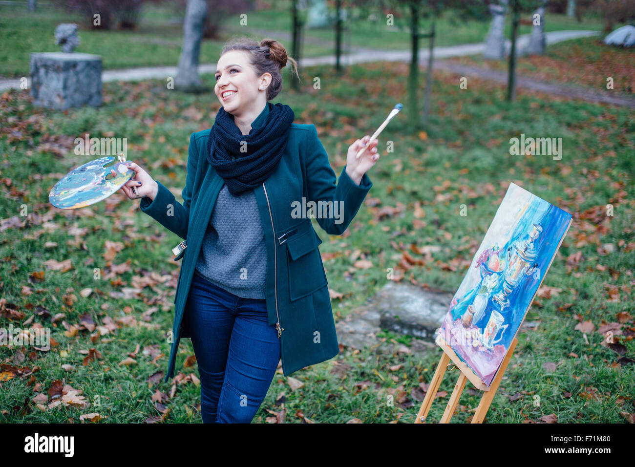 Young woman drawing in easel on the park background Stock Photo - Alamy