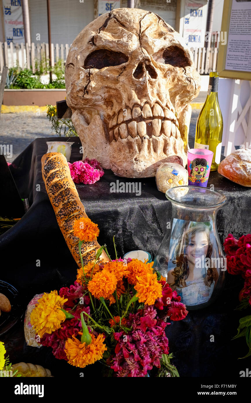 Skull ,flowers and food included in an alter for the Festival of Death celebrated at Halloween in Puerto Vallarta, Mexico Stock Photo