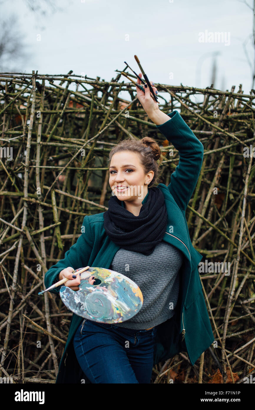 Young woman drawing in easel on the park background Stock Photo - Alamy