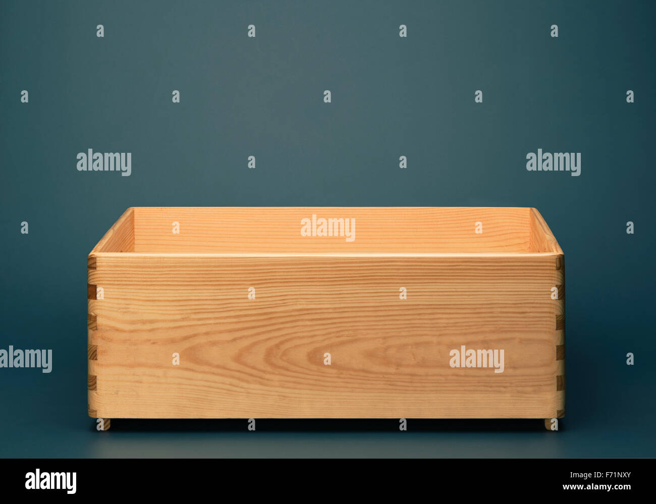 Empty wooden box on blue background Stock Photo