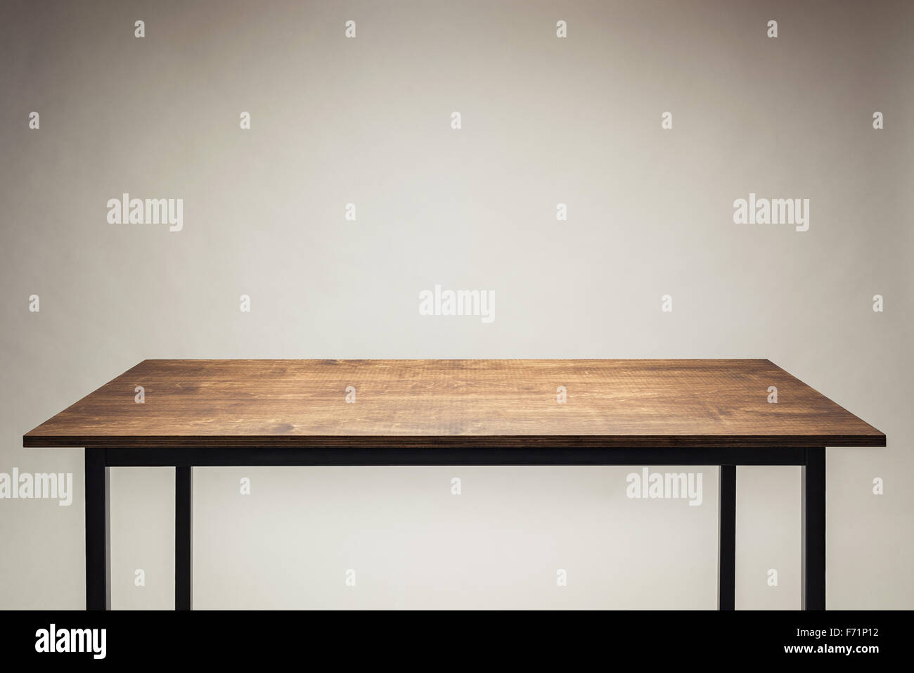 Wooden table against gray background. Stock Photo