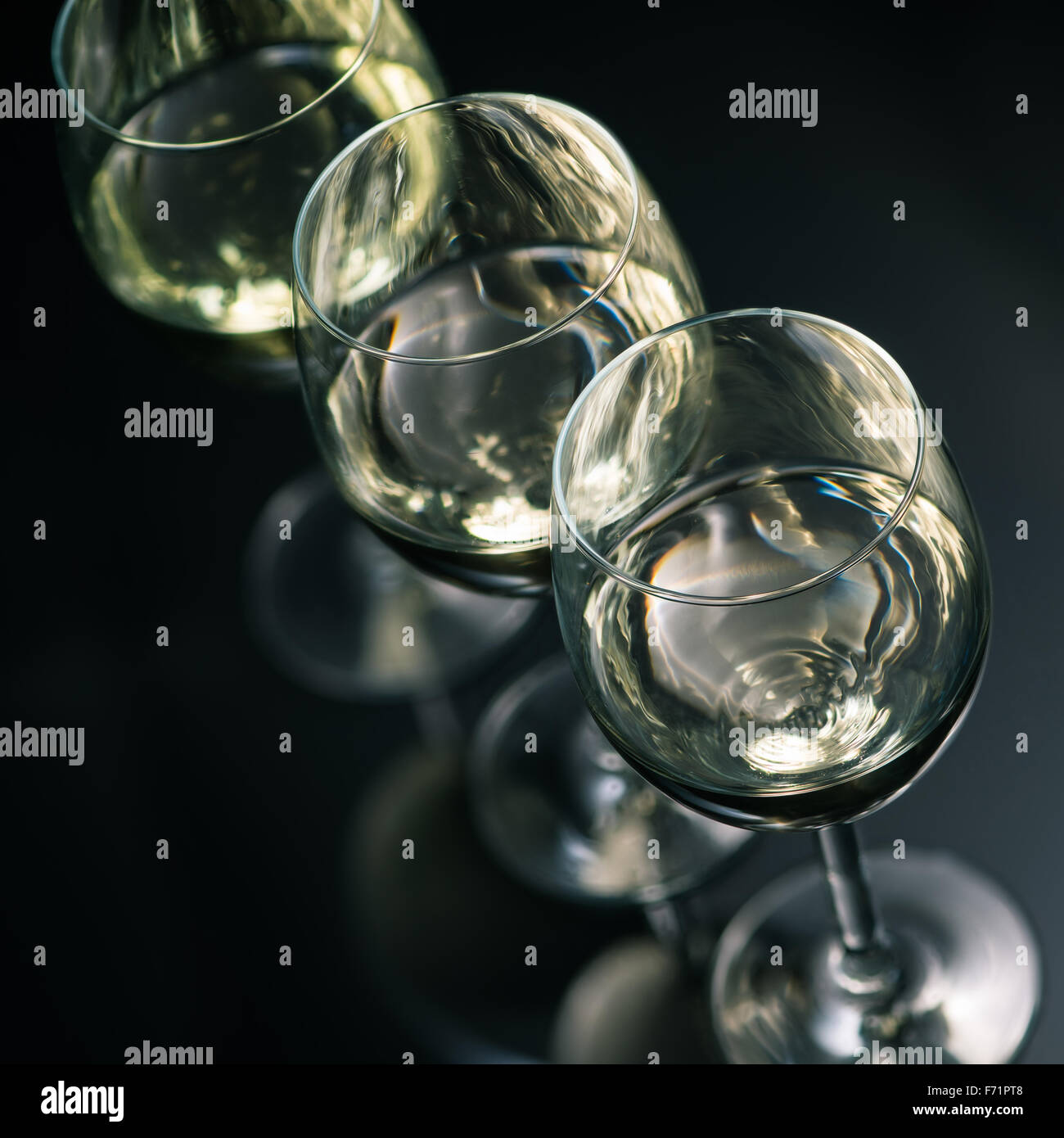 White wine glasses on dark glossy background Stock Photo Alamy