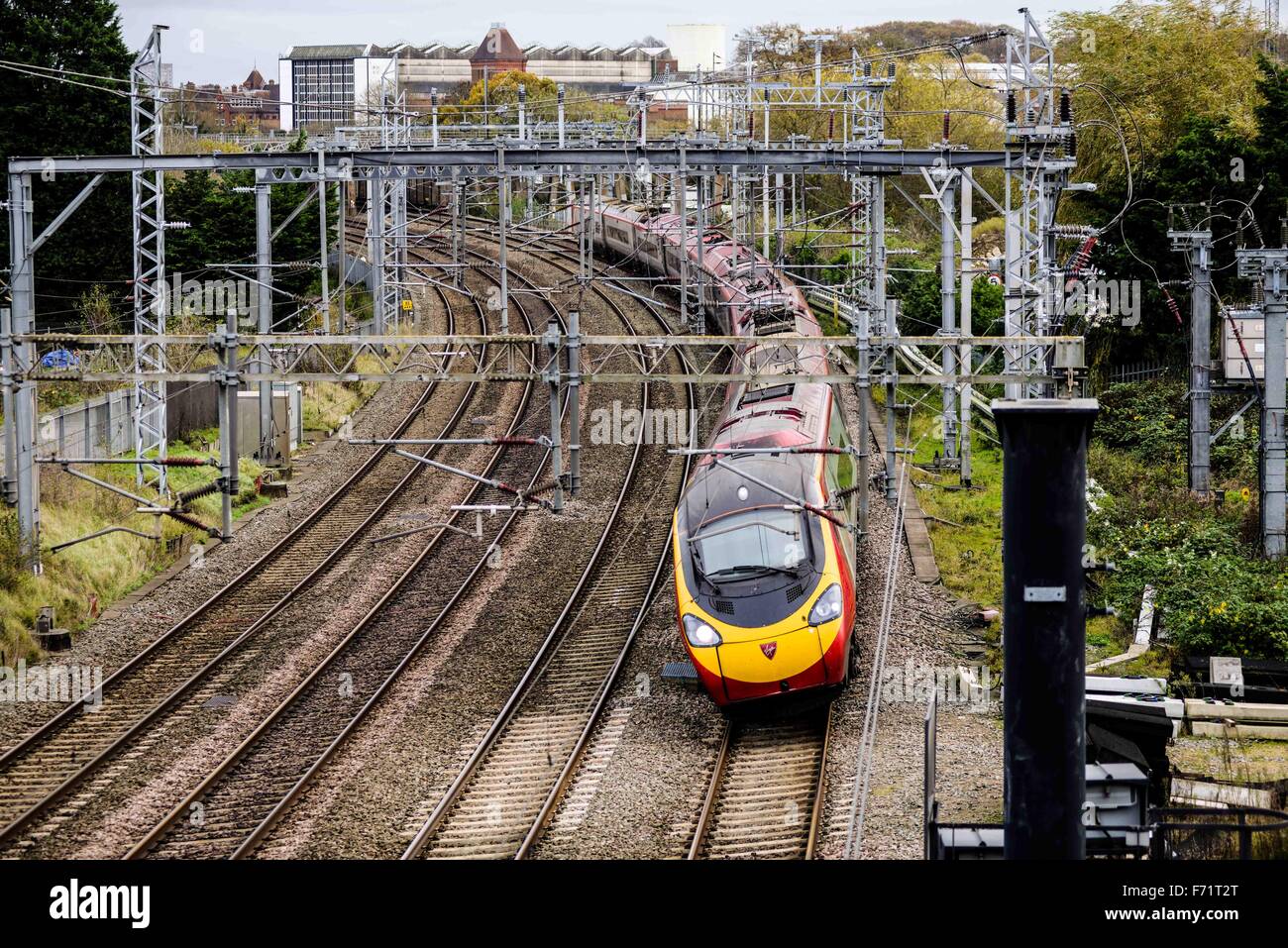 A Virgin Pendolino train tilting as it turns a corner on the tracks. Photographed in Warwickshire, UK. Stock Photo