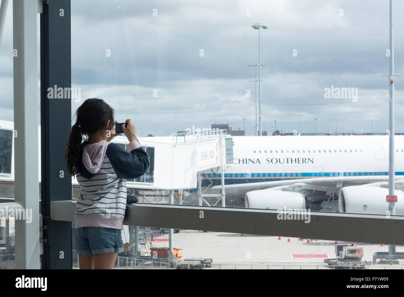 young girl camera taking photo airport Stock Photo