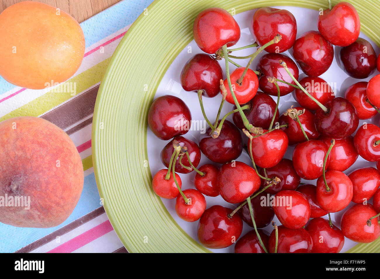 mandarin, peach and cherry fresh fruits and berries, summer health food, top view Stock Photo
