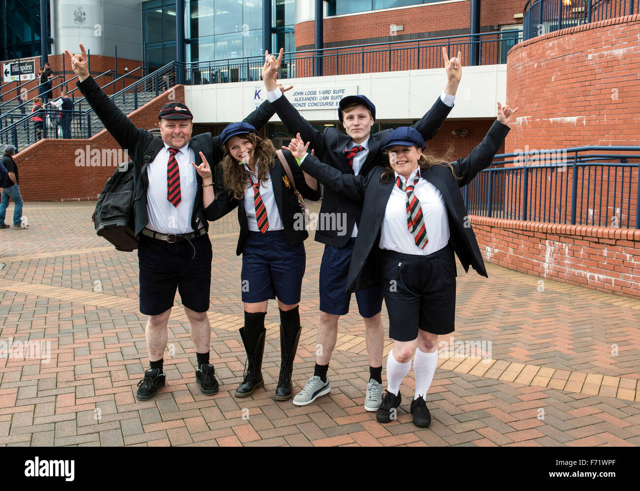 AC/DC fans dressed up as guitarist Angus Young of AC/DC outside of ...