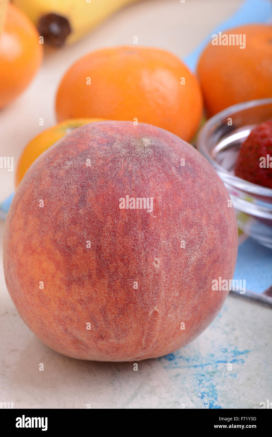 many different fruits for the health of the entire family, peach, mandarin, orange, banana Stock Photo