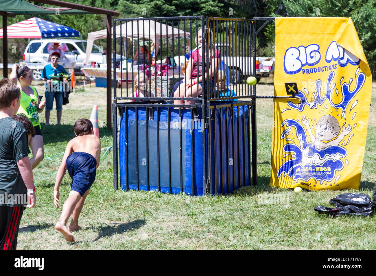 Prospect, Oregon - August 15: Children taking turns un the dunk booth at the Jamboree and Timber Carnival, August 15 2015 in Pro Stock Photo