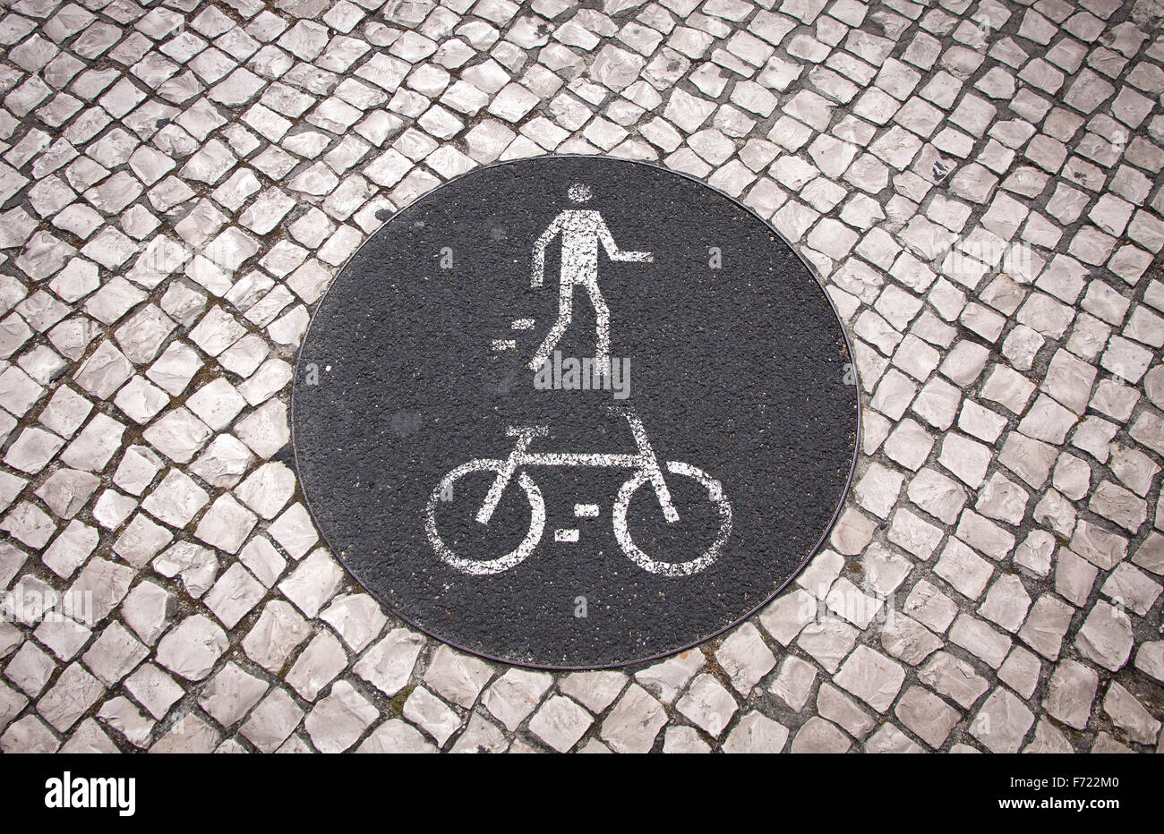 Bicycle and pedestrian lane road sign on the ground in Lisbon, Portugal Stock Photo