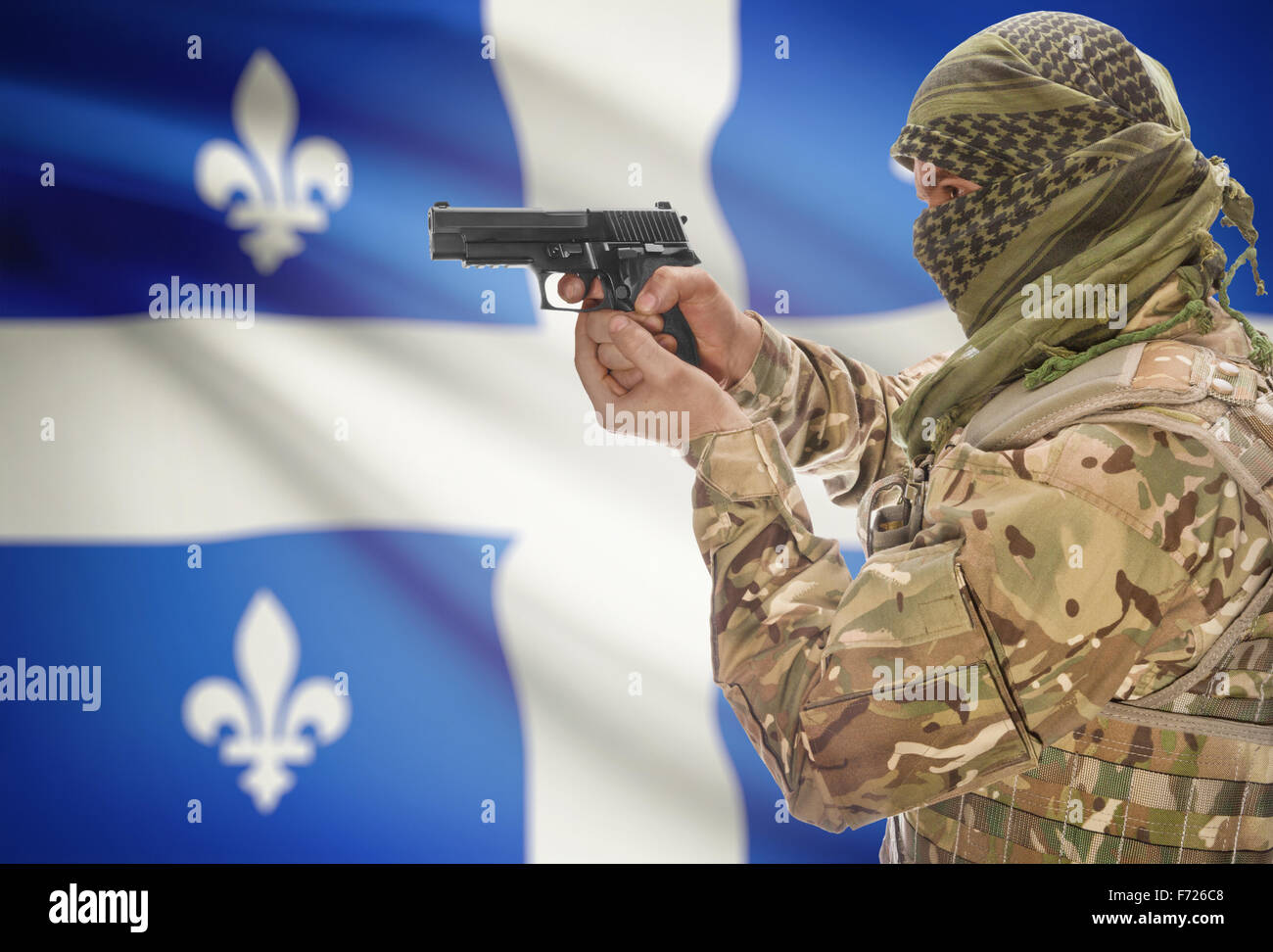 Male in muslim keffiyeh with gun in hand and Canadian province flag on background series - Quebec Stock Photo