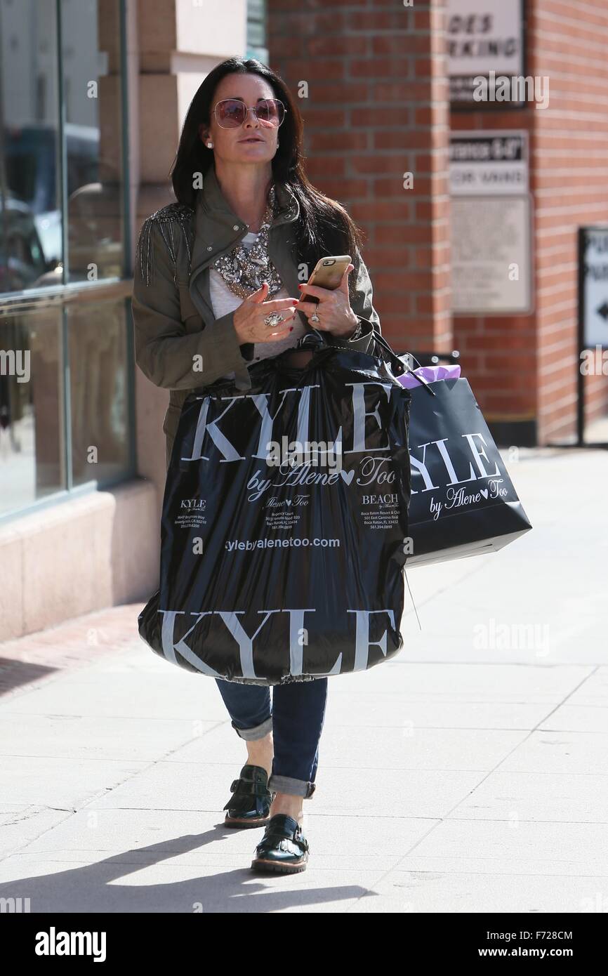 Kyle Richards seen leaving her clothing store carrying lots of bags