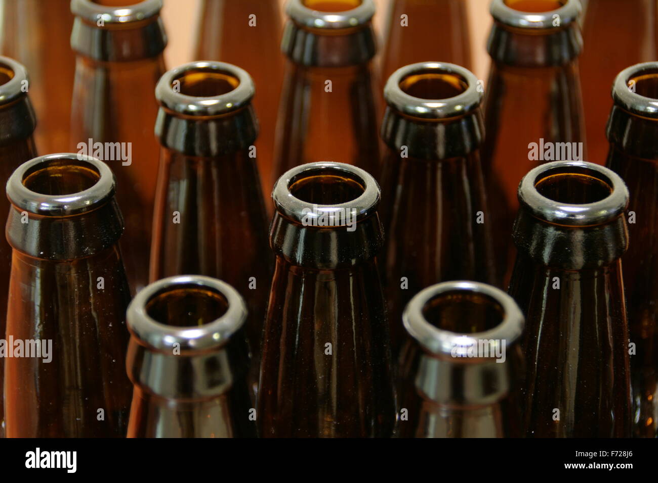Rows of empty brown beer bottles. Stock Photo