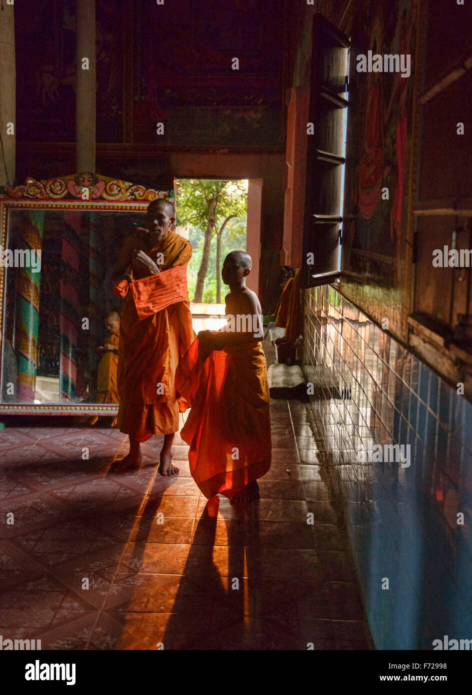 Monks, robes, and late afternoon light at Kampong Phluk, Siem Reap, Cambodia Stock Photo