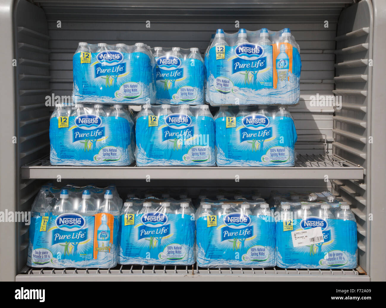Bottled spring water packs wrapped in plastic for sale at gas station. Stock Photo