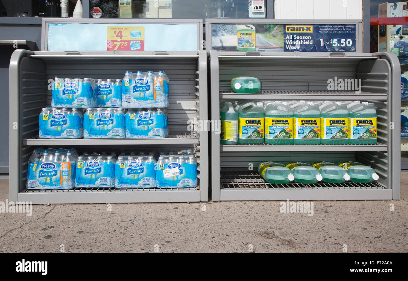 Bottled Water Packs Wrapped In Plastic And Windshield Washer Fluid For Sale At Gas Station Bottled Water Packs Wrapped In Plastic And Windshield Washer Fluid For Sale At Gas Station