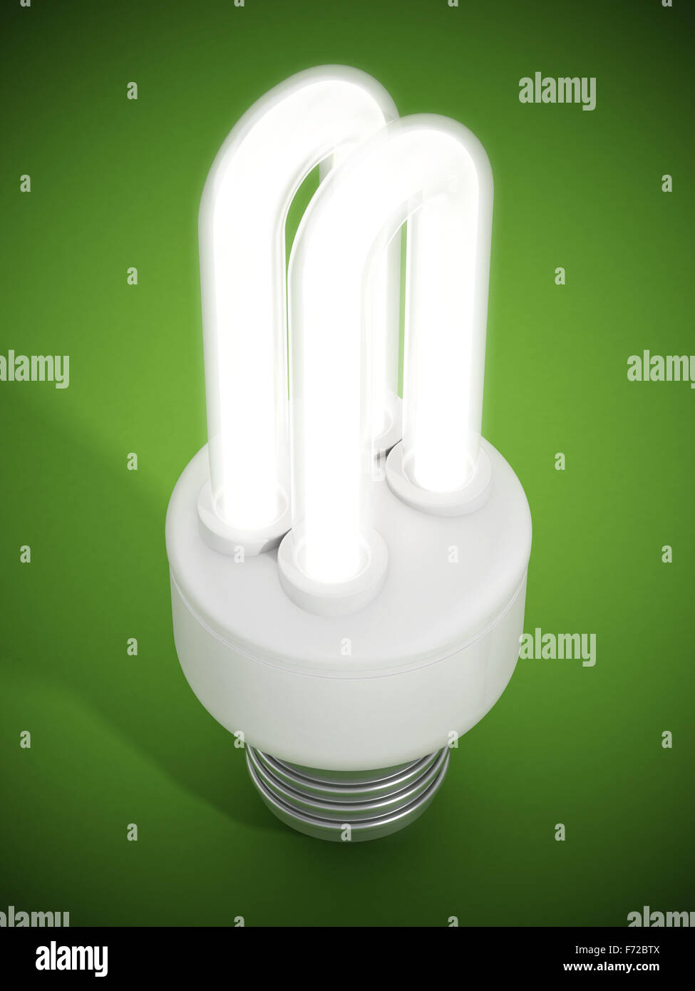 Fluorescent energy saving lightbulb on green surface Stock Photo - Alamy