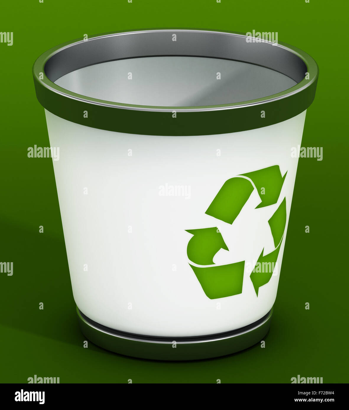 Recycle bin standing on green background Stock Photo