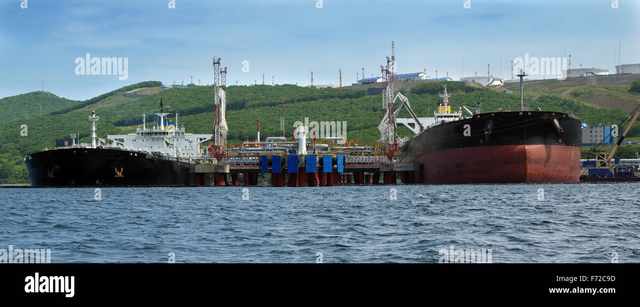 two tankers are in port under loading of oil Stock Photo