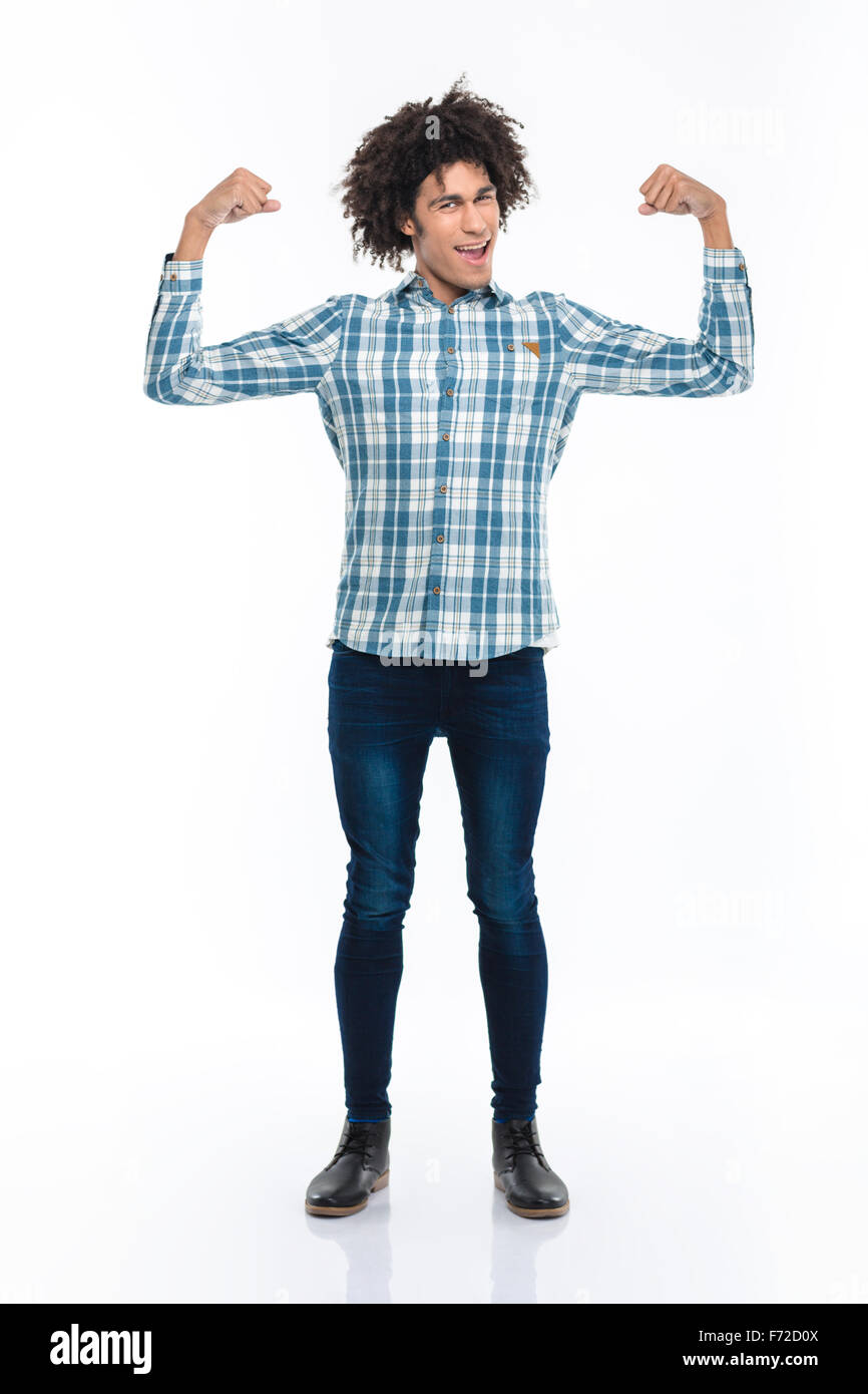 Full length portrait of a cheerful afro american man showing his biceps isolated on a white background Stock Photo