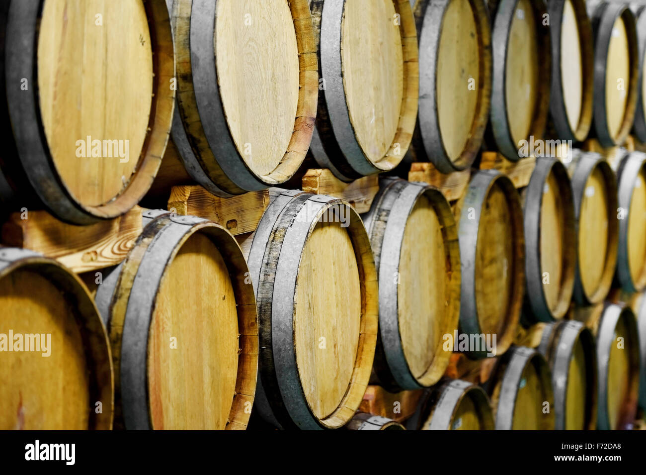 Detail shot with dozens wooden wine barrels in a wine cellar Stock