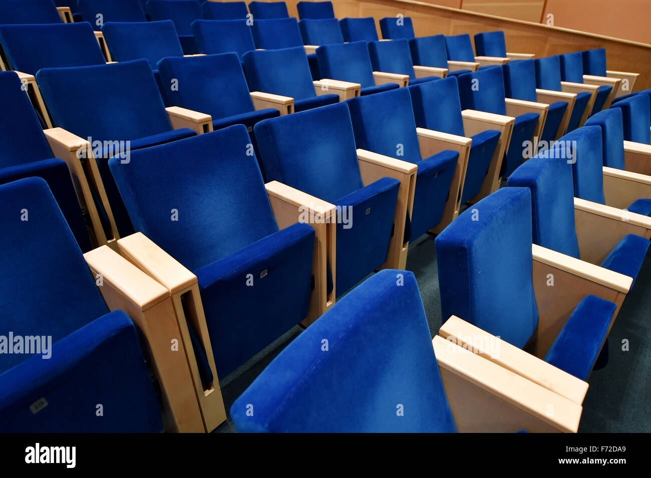Empty blue velvet chairs inside an amphitheater Stock Photo