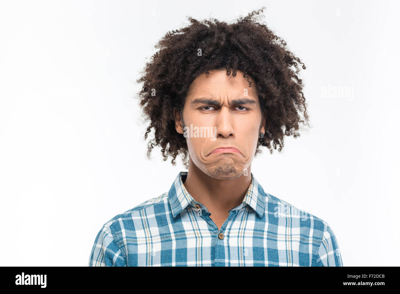 Portrait of a sad afro american man with curly hair looking at camera isolated on a white background Stock Photo