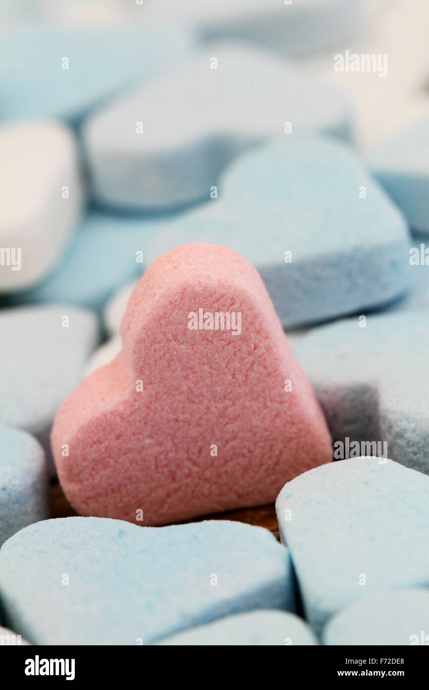 Pink sugar heart among white and blue sugar hearts Stock Photo