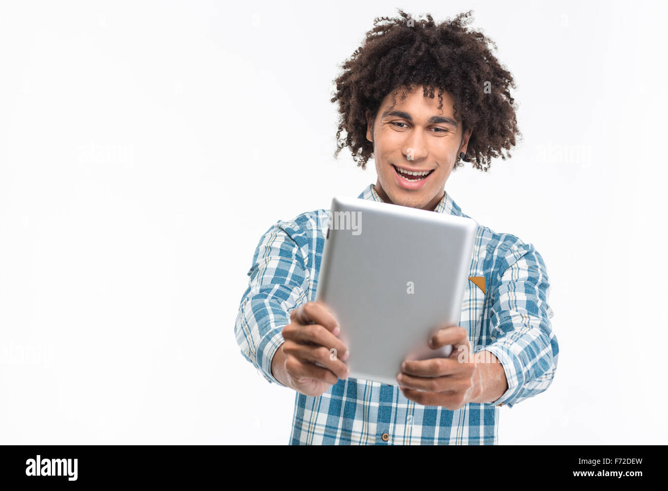 Portrait of a cheerful afro american man using tablet computer isolated on a white background Stock Photo