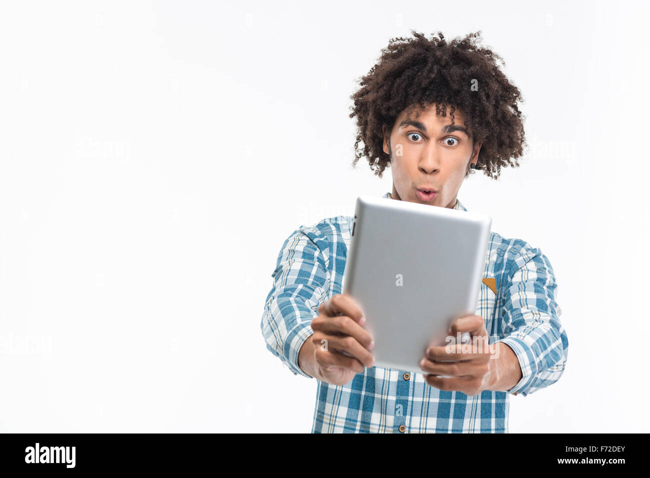 Portrait of a funny afro american man using tablet computer isolated on a white background Stock Photo