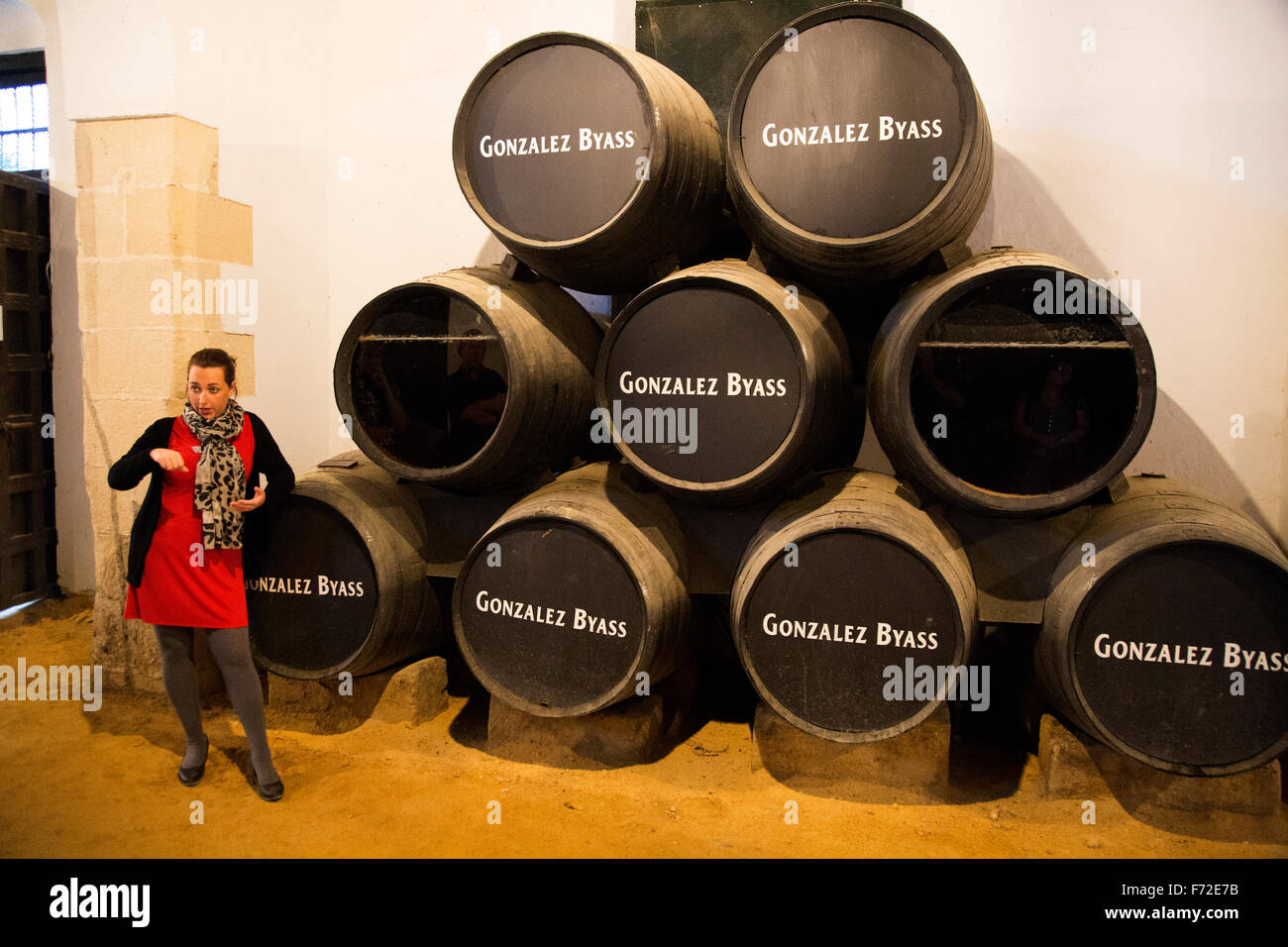 Female guide explaining fino sherry production wine cellar, Gonzalez