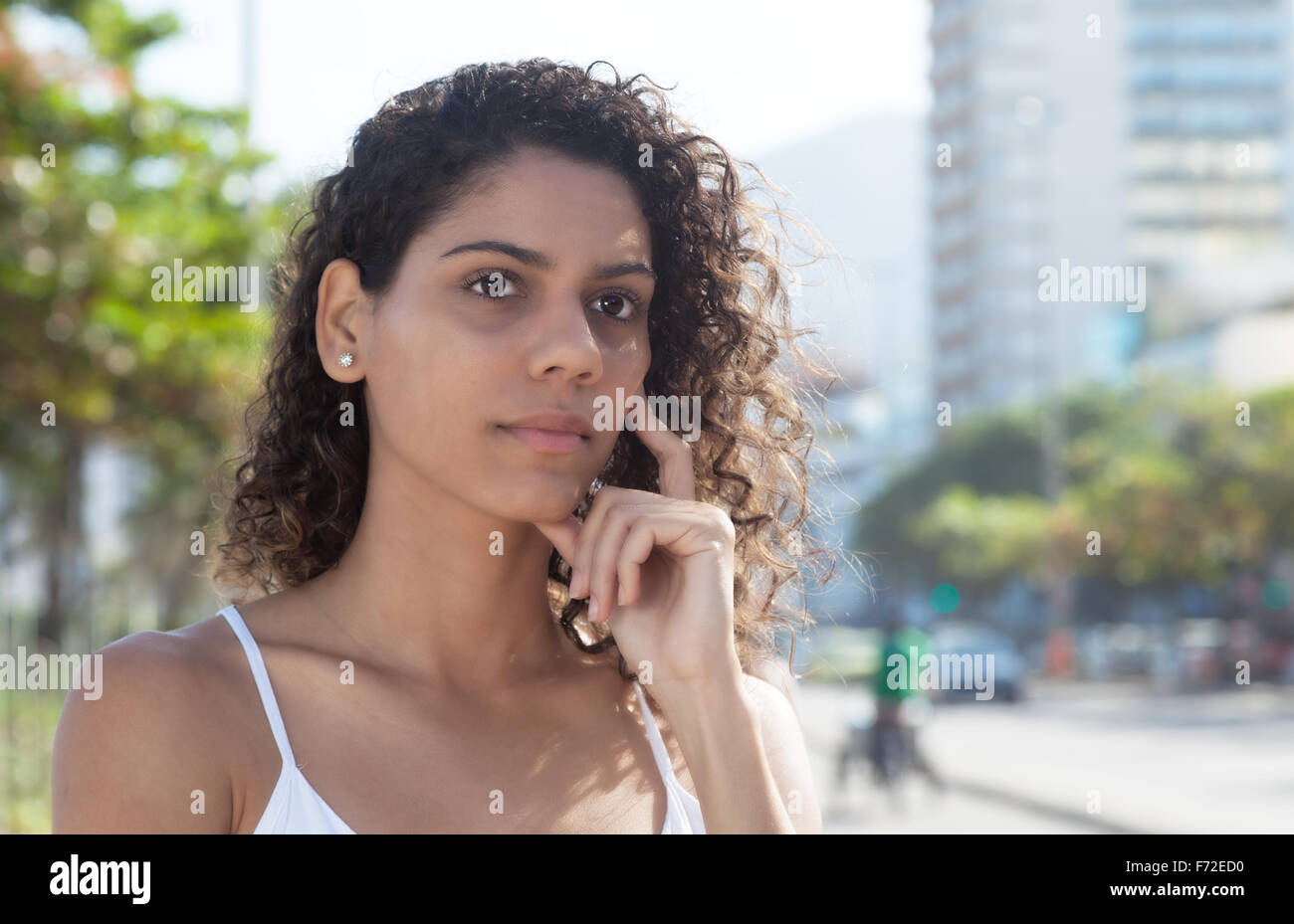 Thinking latin woman in a city of latin america Stock Photo