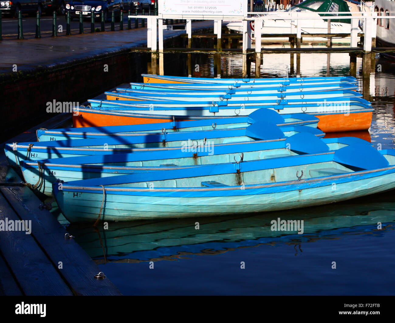 Rowing boats for hire aligned at the Thames in Henley-on-Thames, Oxfordshire, England, UK Stock Photo
