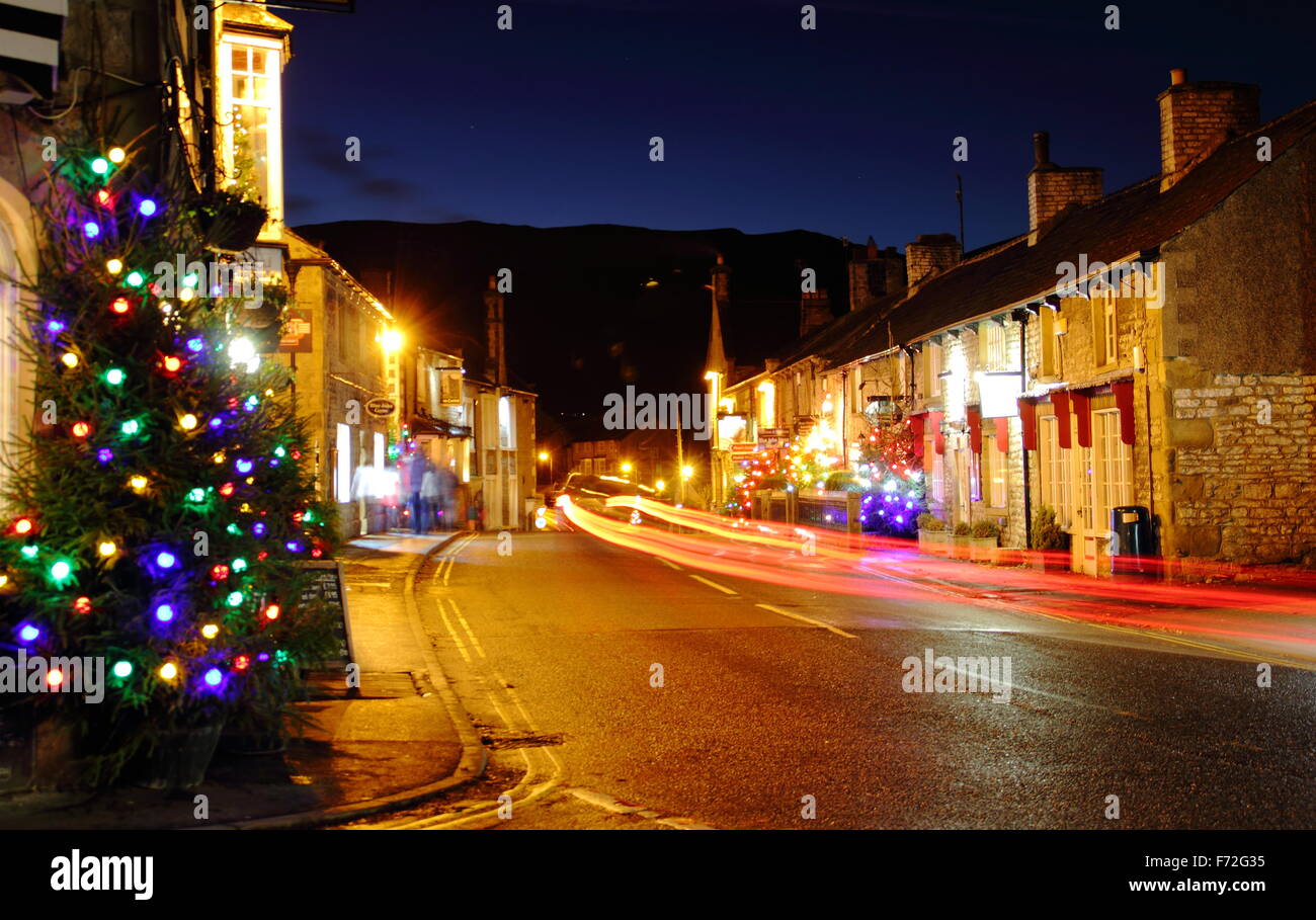 Christmas decorations light up the main street in Castleton, a village in the Hope Valley, Peak District Derbyshire England UK Stock Photo