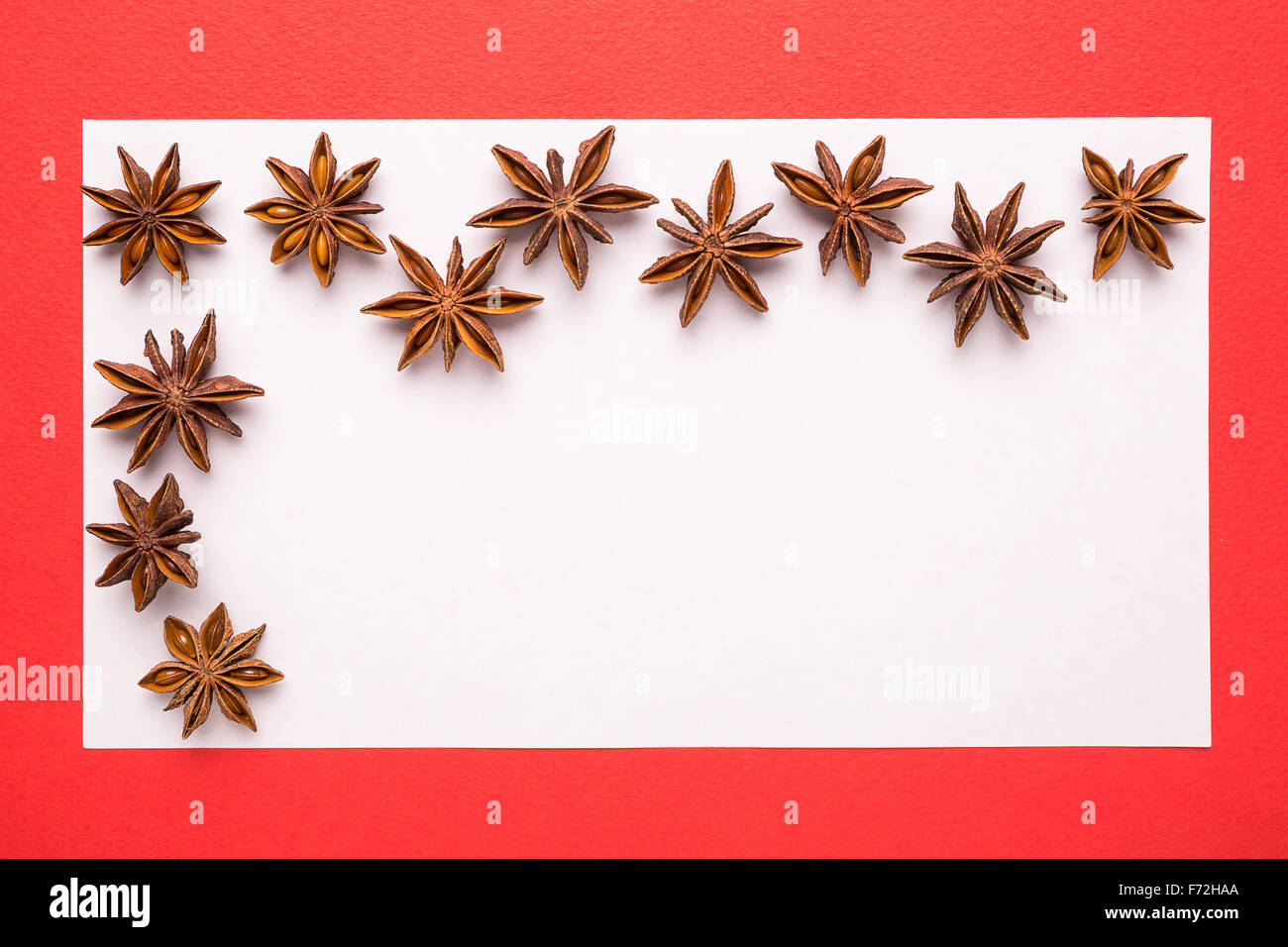 blank Christmas card with anise star on red background Stock Photo