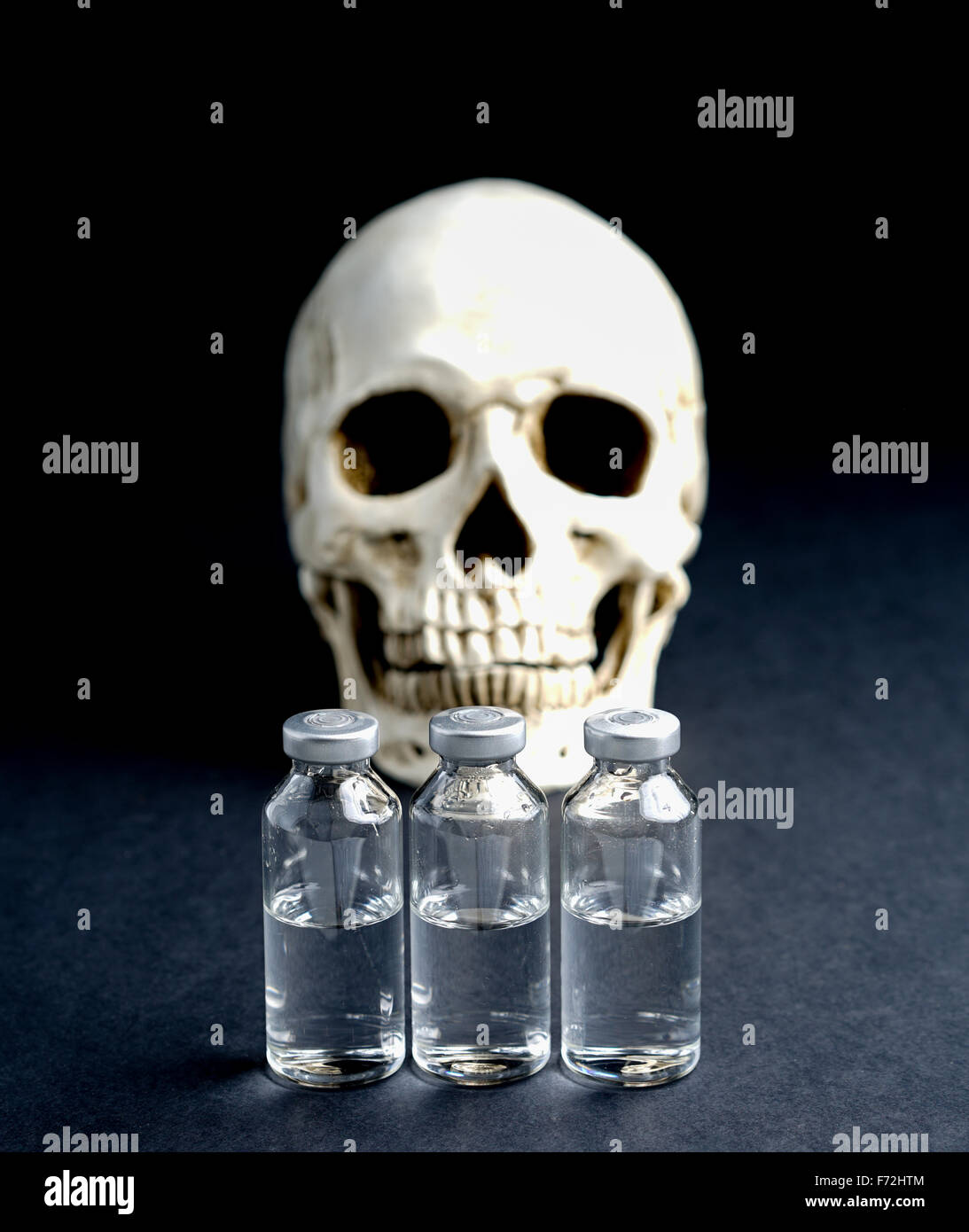 Skull and medical vials risk of death or abuse Stock Photo