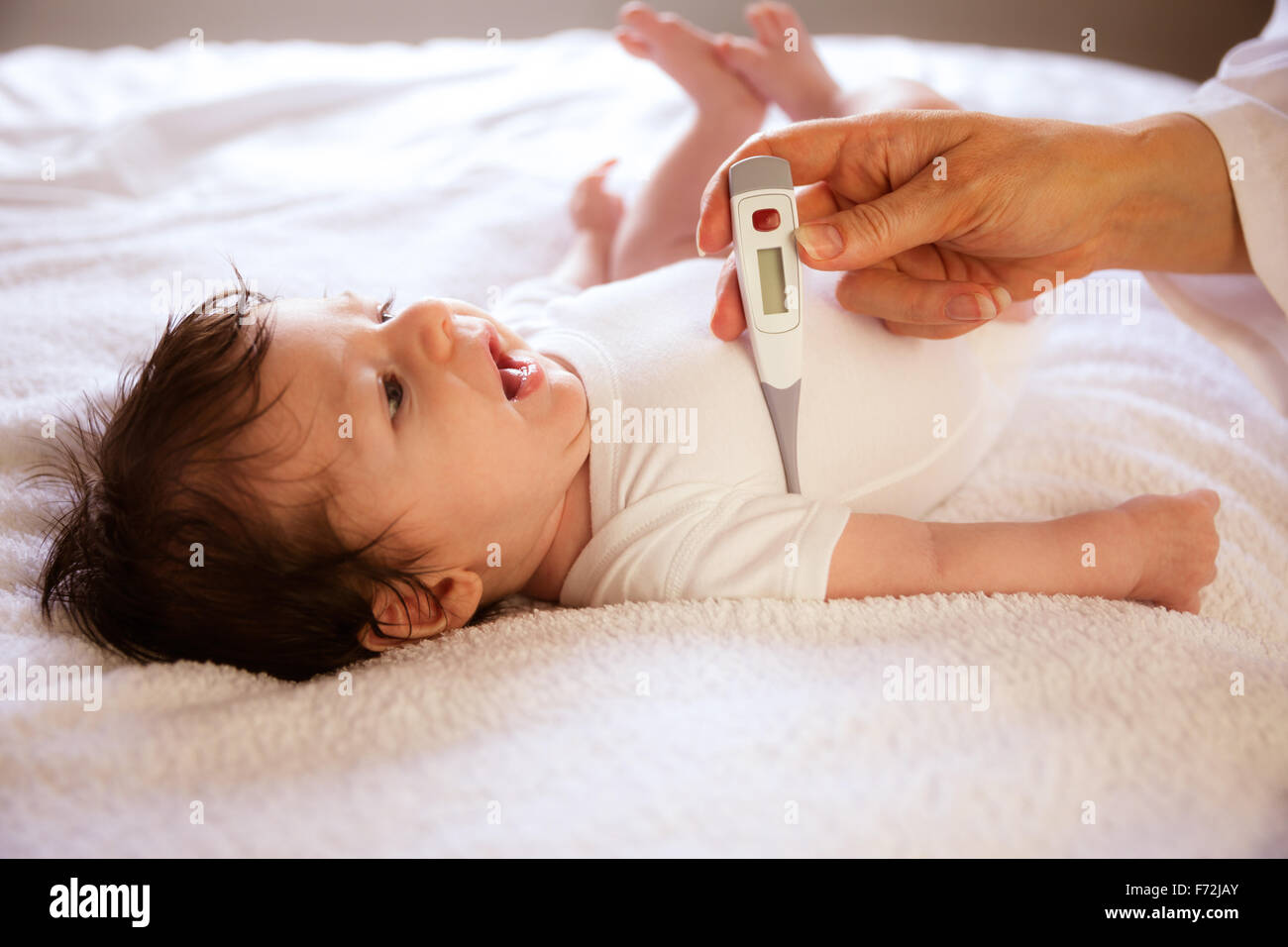 Pediatrician checking newborn temperature Stock Photo Alamy