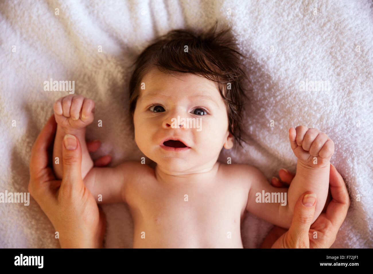 Cute newborn laying on changing table Stock Photo Alamy