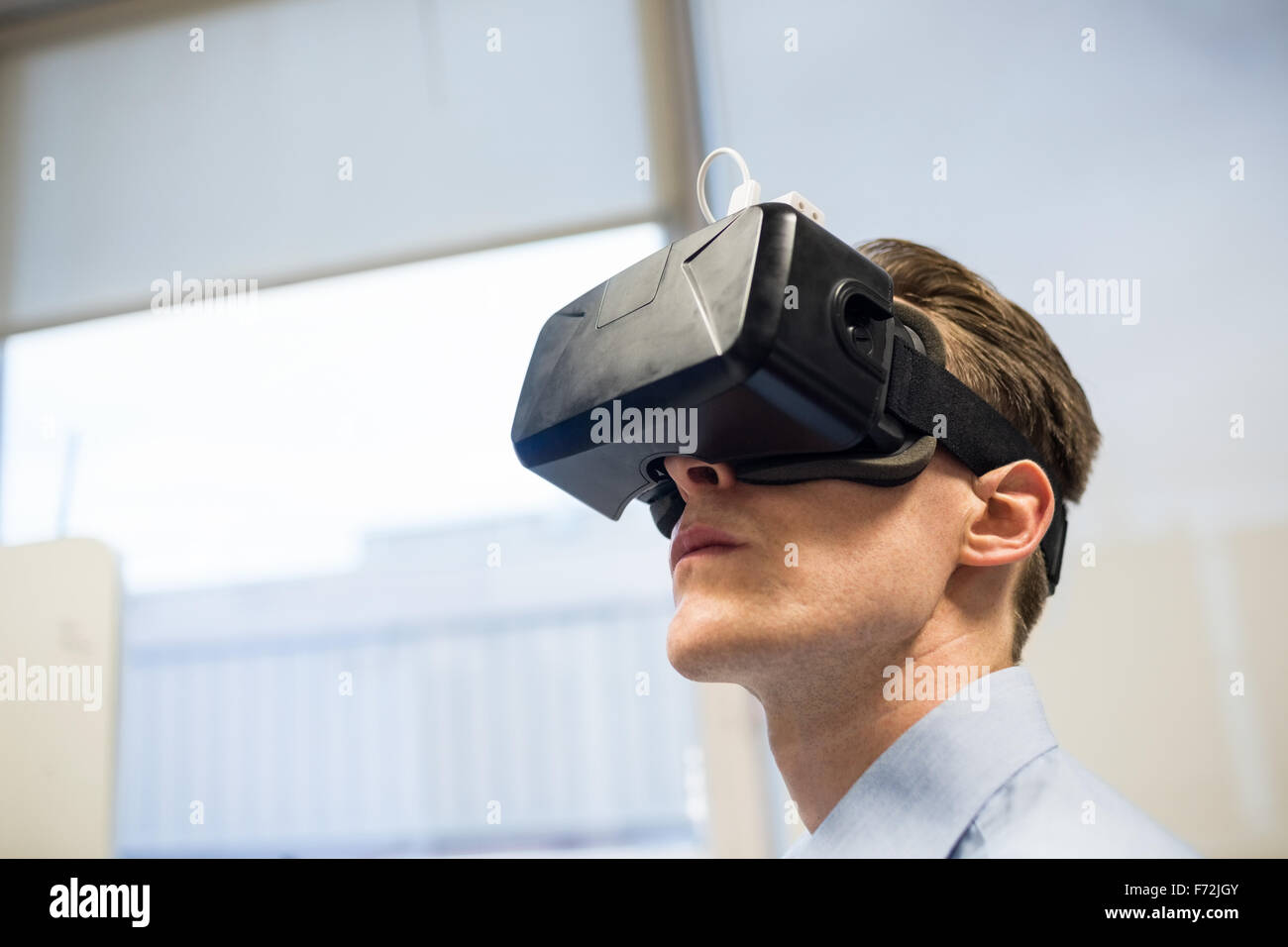 Businessman using oculus rift headset Stock Photo