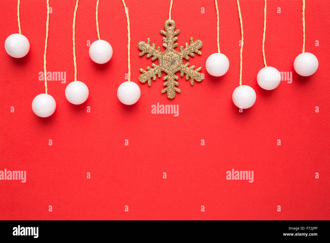 christmas card with hanging decor on red background Stock Photo