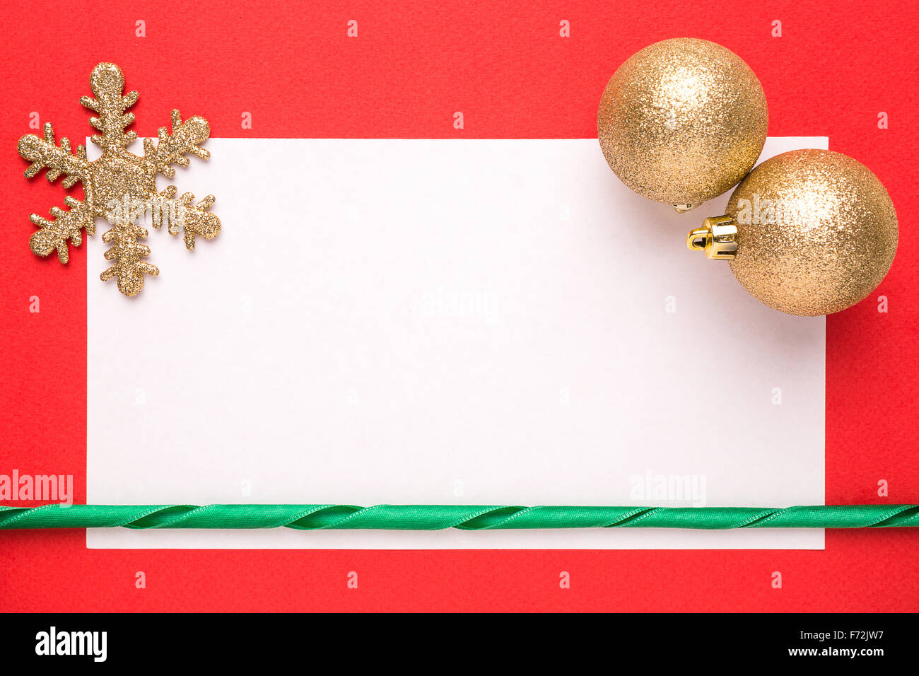 Blank Christmas card or invitation with golden snowflake and balls on red background Stock Photo