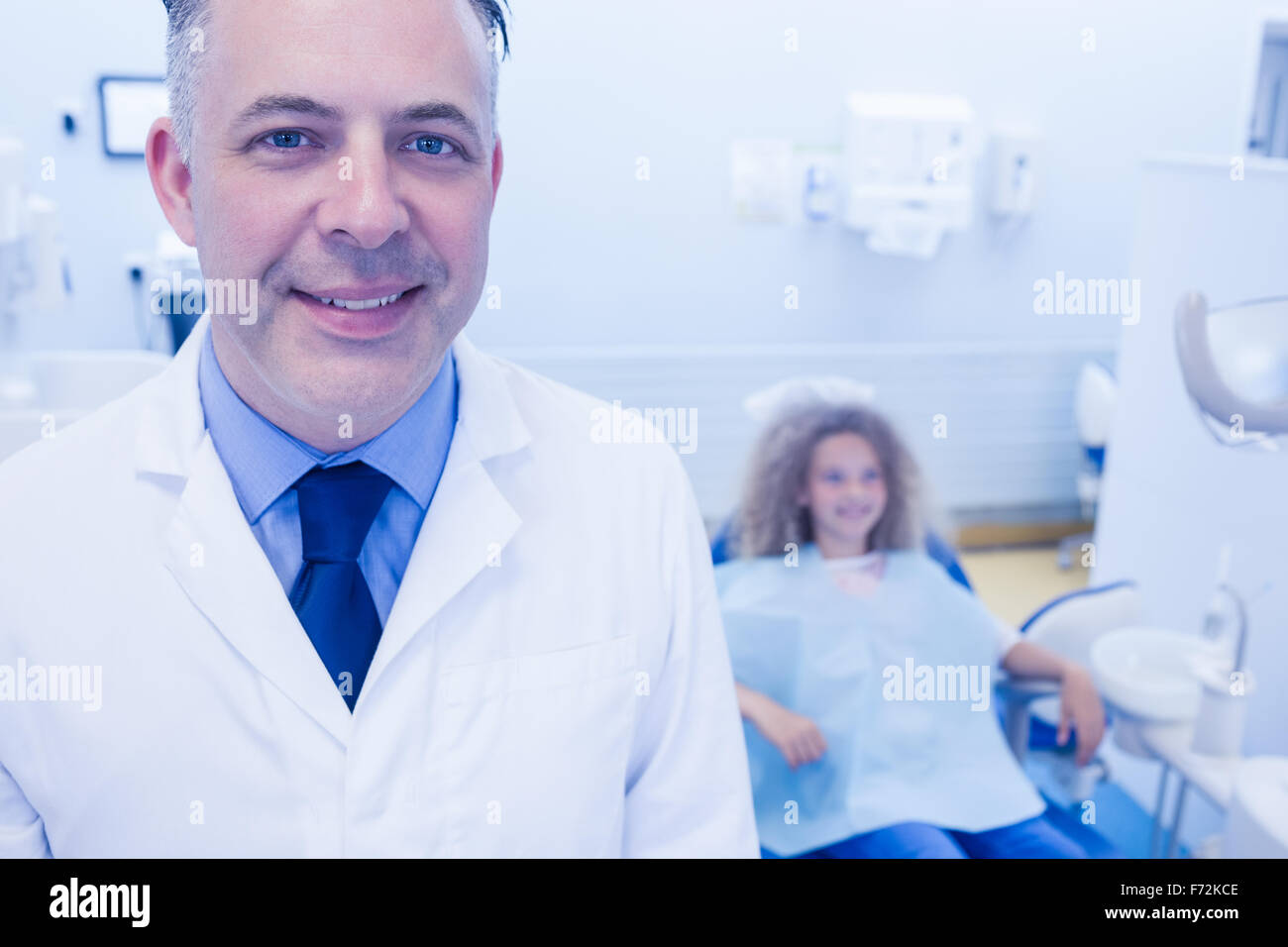 Pediatric dentist and little girl smiling at the camera Stock Photo Alamy
