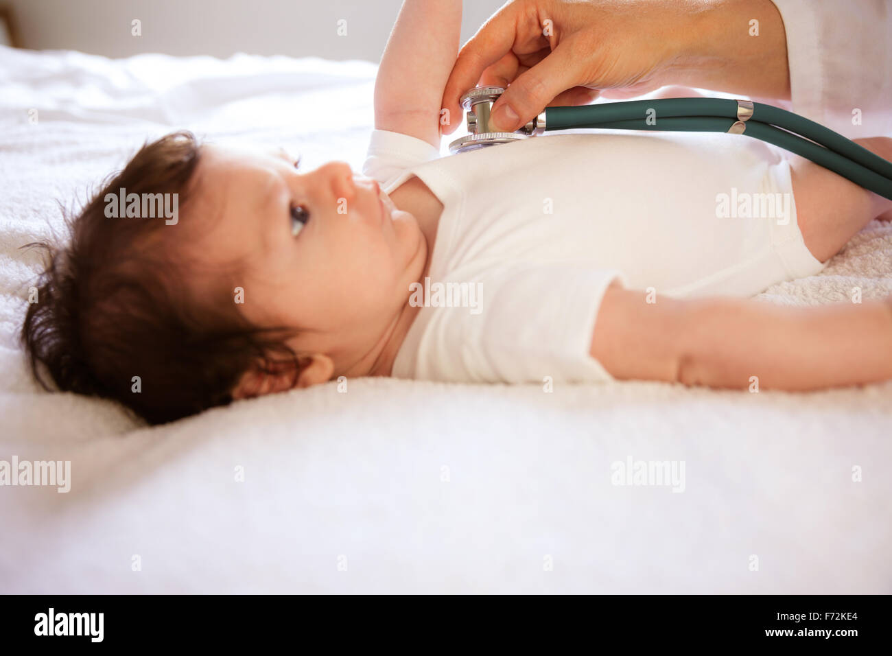 Newborn being visited by pediatrician Stock Photo
