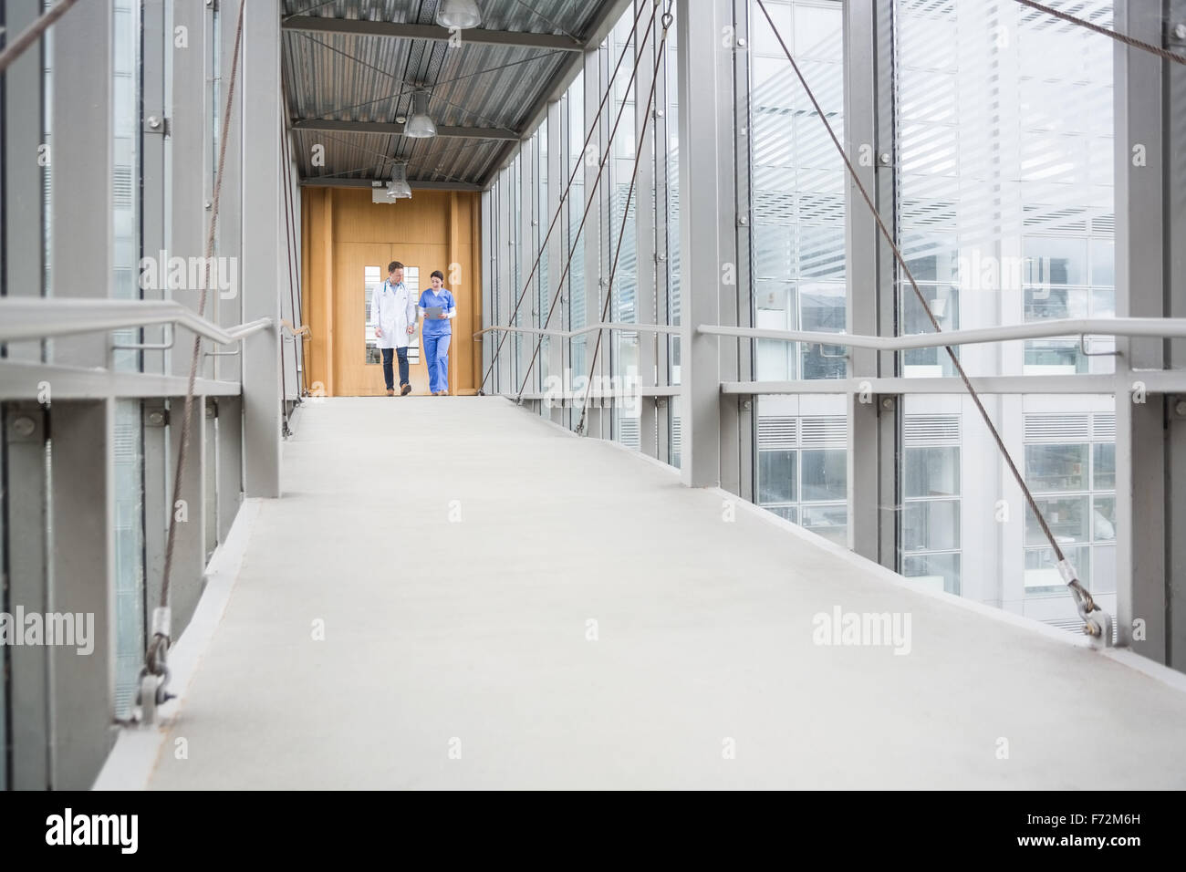 Nurse walking down hospital hallway hi-res stock photography and images ...
