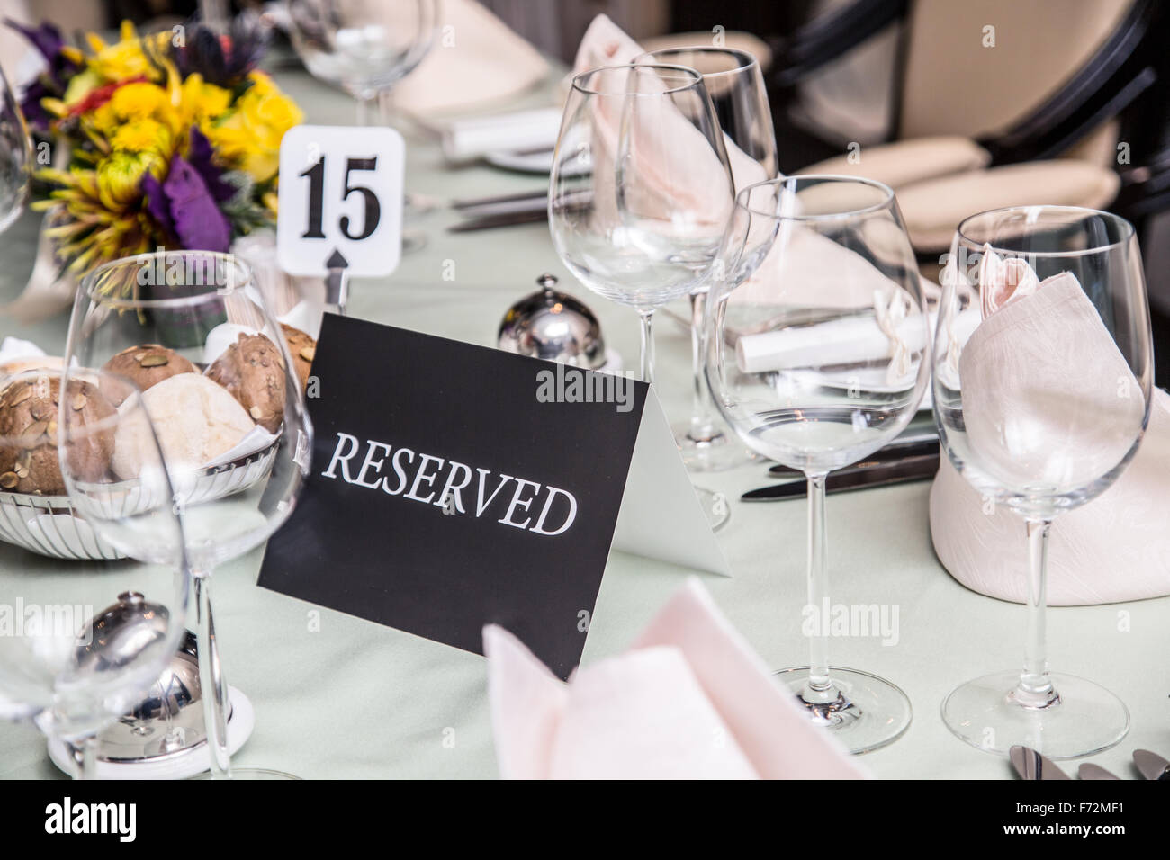 Festival dinner setting and 'Reserved' sign. Stock Photo